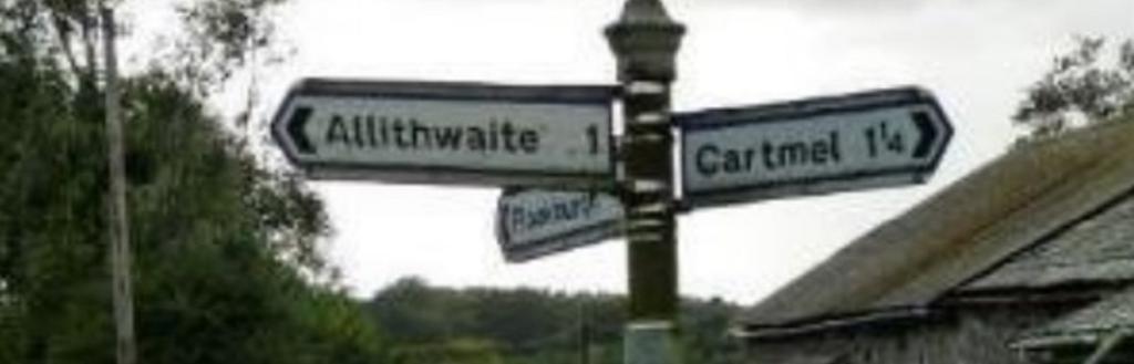 Signpost pointing to Allithwaite and Cartmel.