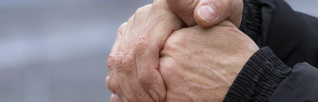 A person clasping their hands