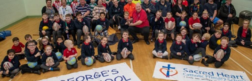 Pupils who have taken part in Step Up and Play with members from the sports clubs and volunteers who transport children to the activities.