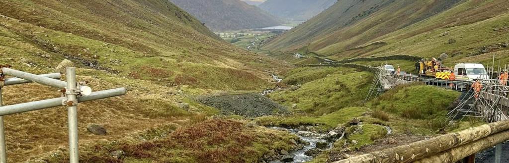 View of down the valley of Kirkstone Pass with the wooden-clad barriers being installed