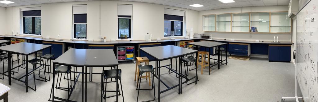 A row of desks in a science classroom.