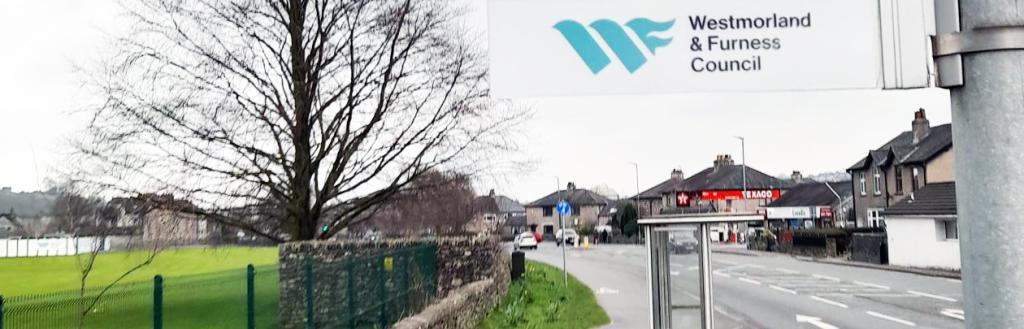 Westmorland and Furness Council bus stop sign on a road