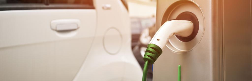 An electric car plugged into a charging point