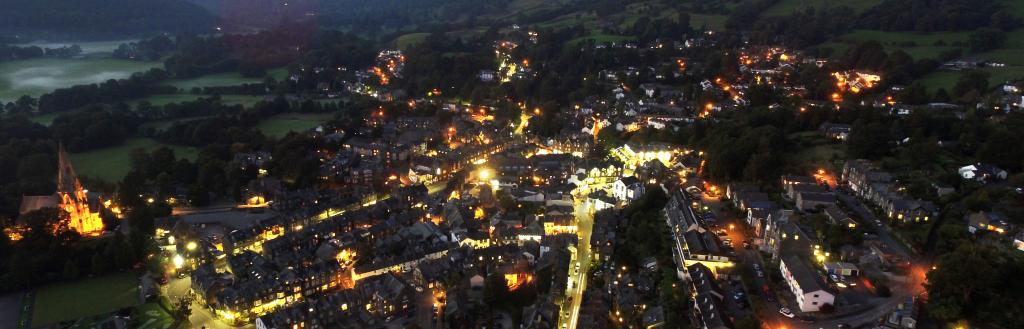 Aerial view of Ambleside at night lit by streetlights 