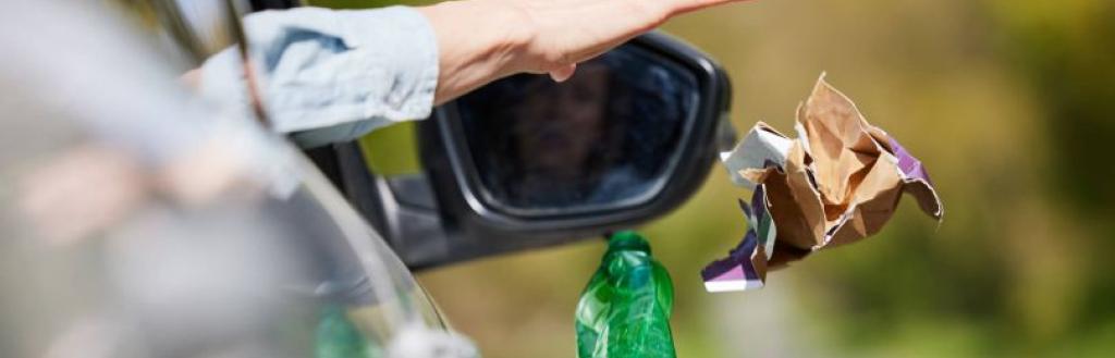 A motorist dropping litter out of a car window