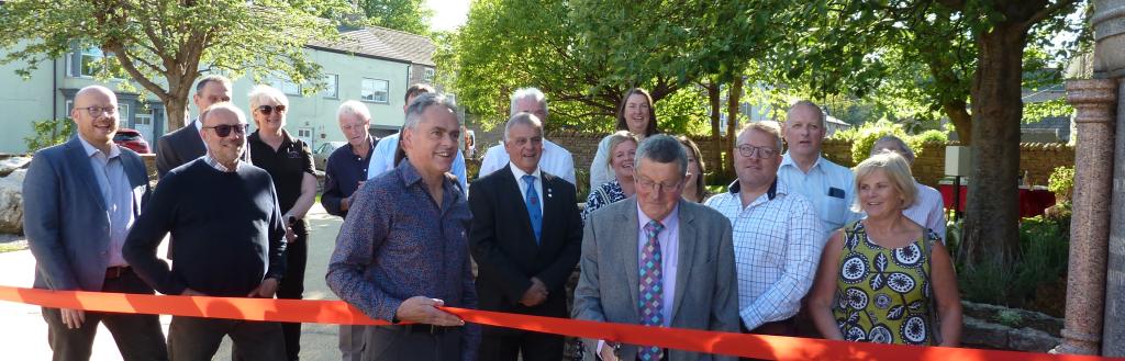 Stuart Johnstone cutting the ribbon at the opening of SIlver Street Memorial Garden.