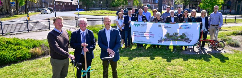 • 'Spade in the ground' marking the start of the Abbey Road cycling and walking scheme construction conducted by Westmorland and Furness Council Cabinet Member, Cllr John Murray (centre), Active Travel England North West Regional Manager, Nick Chamberlain (left) and Steve Cole, Chair of the Brilliant Barrow Board, and CIO and Operational Improvement Director at BAE Systems (right)