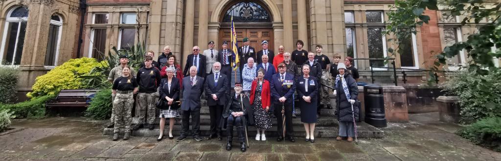 Local dignitaries, veterans, cadets and members of the RBL at the Armed Forces Day flag raising ceremony outside the town hall building in Penrith