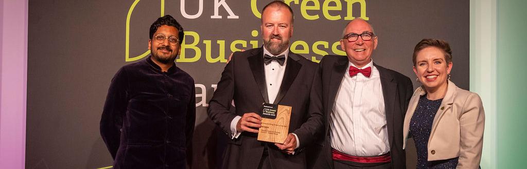 Winners of Green Energy Awards holding trophy