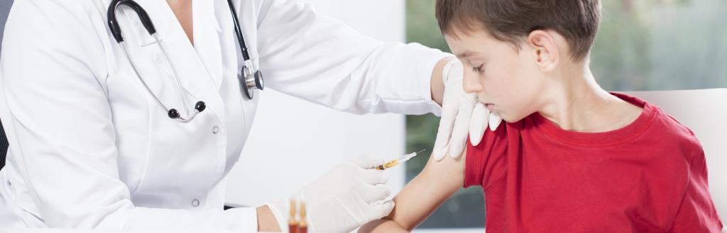 doctor helping child have immunisation
