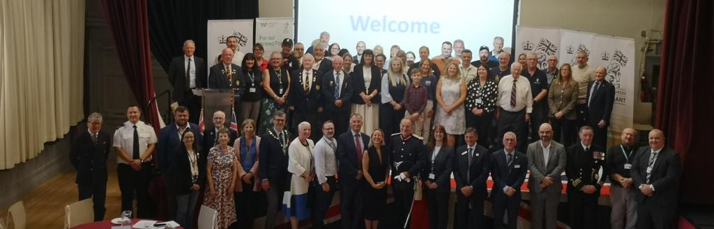 Attendees stood on stage at Armed Forces Community Collaboration Event