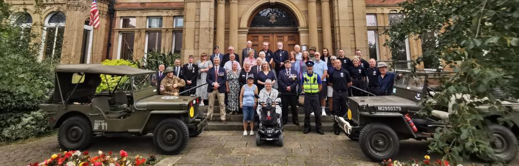 VJ Day flag raising event outside the town hall building in Penrith