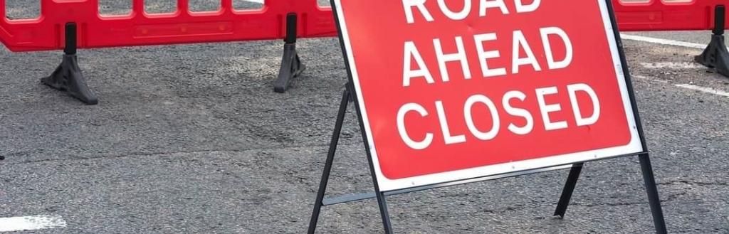 A sign saying "Road ahead closed".