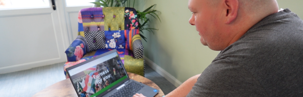 Man looking at Furness For You website on a laptop
