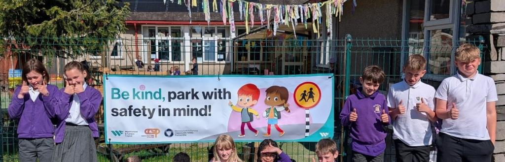 School children with a road safety banner