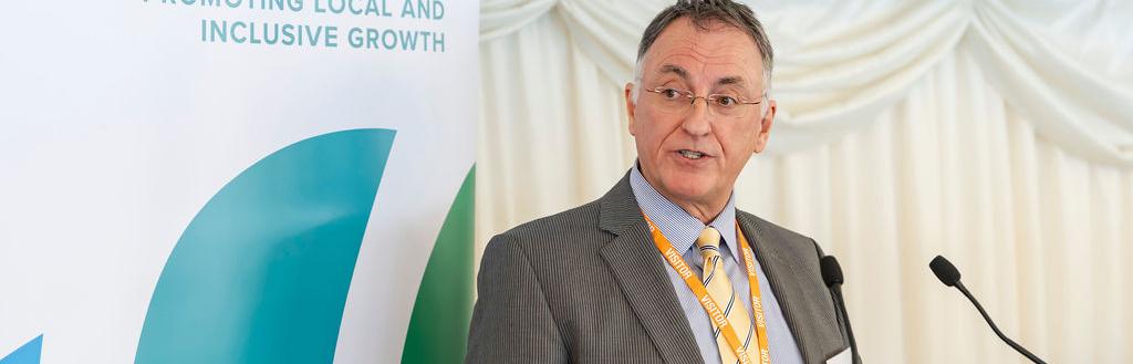 Councillor Jonathan Brook standing at a lecturn giving a speech.