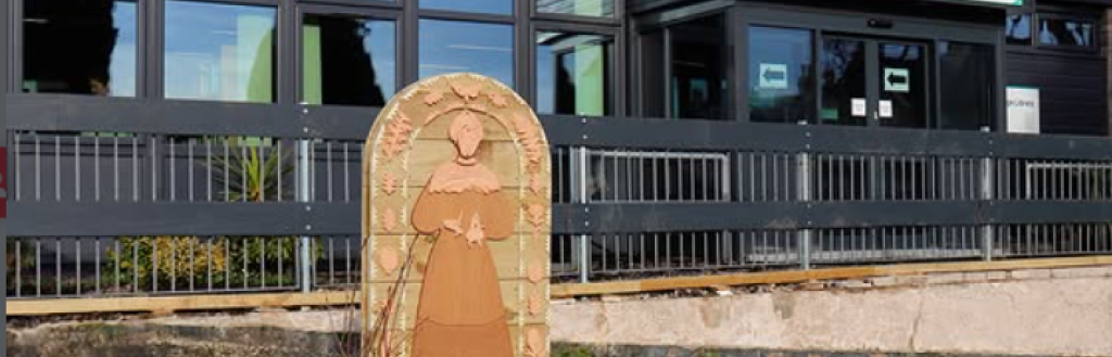 A carved wooden planter in the grounds of Grange Library.