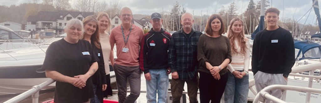 A group photograph of the team from the Windermere Marina Village and the Council's Skills Bridge Tutor, Peter Harrison, after completing the Level 1 Mental Health & Wellbeing Course
