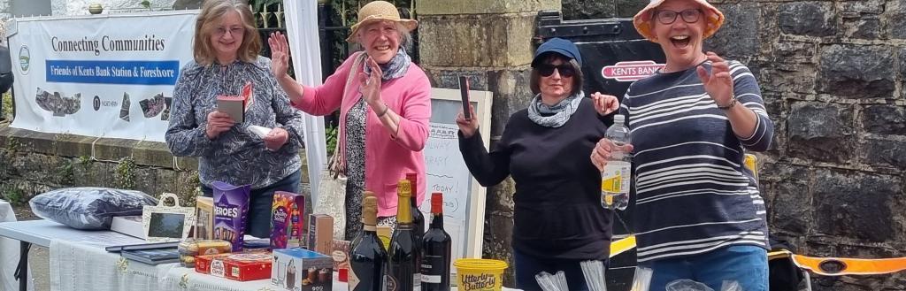 Several women volunteers at a stall at a community fete.