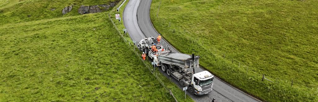 Surface dressing work being carried out on a road in Westmorland and Furness
