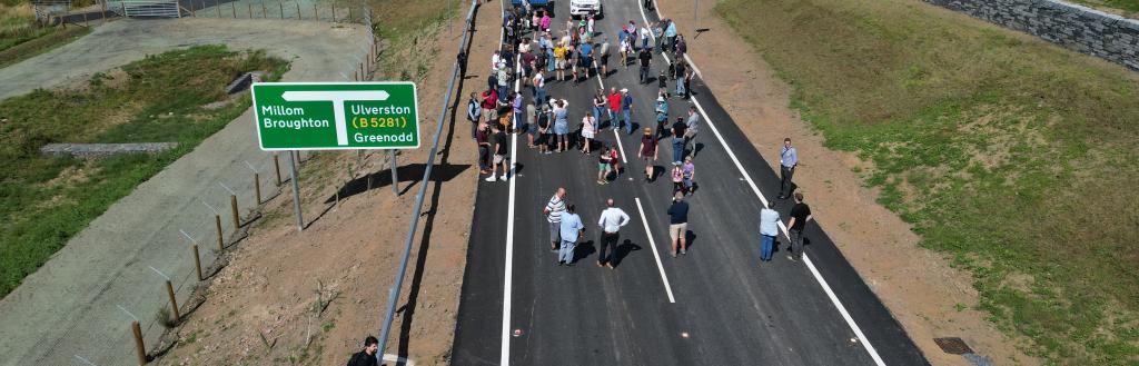 A drone view of people walking along the new road.