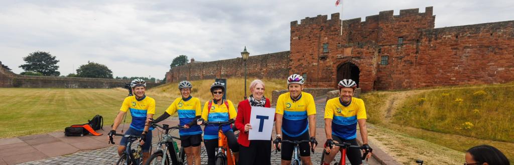 Cyclists pictured at Carlisle Castle ahead of charity cycling challenge