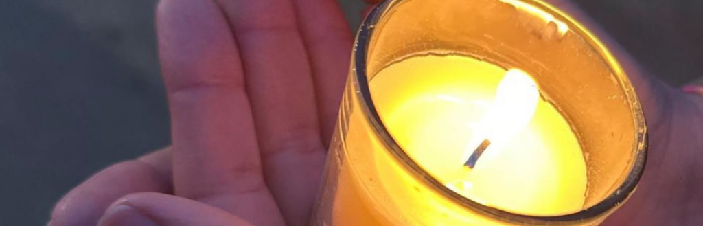 Hands holding a candle